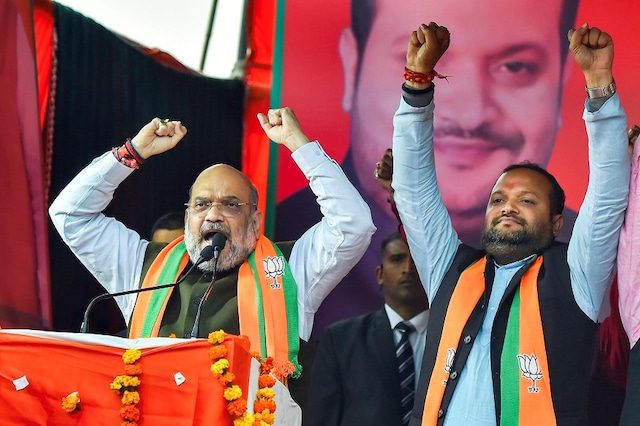 Union Home Minister and BJP leader Amit Shah with party candidate Manish Choudhary (R) during an election campaign ahead of the forthcoming Delhi Assembly elections, at Rithala constituency in New Delhi, Monday, Jan. 27, 2020. (Image: PTI)