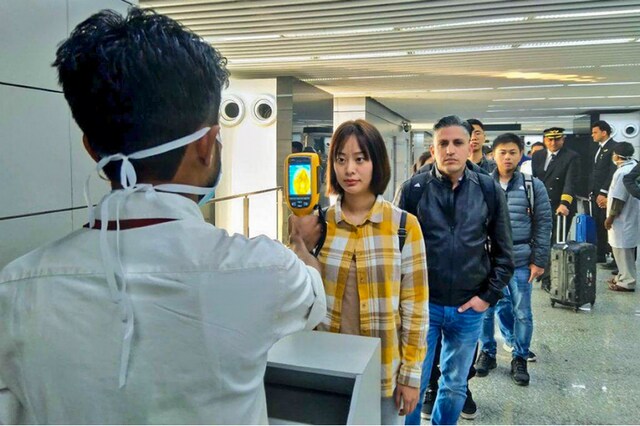 A thermal screeening device checks passengers arriving from China at the Kolkata airport on Tuesday. (PTI)