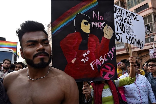 People hold a placard against a new citizenship law as they participate during Rainbow Pride Walk, an event promoting gay, lesbian, bisexual and transgender rights, in Kolkata. (Image: Reuters)