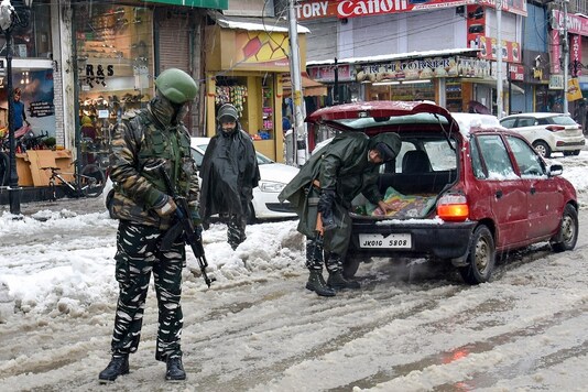 For representation: A security personnel checks a vehicle as others stand guard. (PTI/File photo)