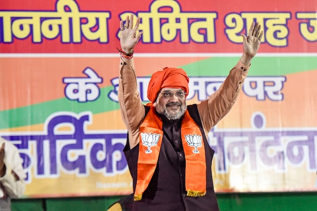 Home Minister Amit Shah waves at supporters during a rally in Delhi. (PTI)