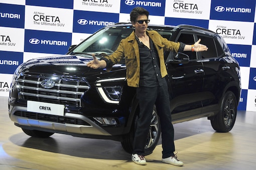 Shah Rukh Khan poses next to the newly launched Hyundai Creta SUV at the Auto Expo 2020 at Greater Noida in New Delhi. (Image: Viral Bhayani)