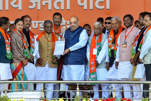 File photo of Union Home Minister Amit Shah (C) receives a memorandum from MP’s of Jharkhand state during a ‘samaroh’ program to merge Jharkhand Vikas Morcha (Prajatantrik) party and Bharatiya Janata Party, at Prabhat Tara ground in Jagannathpur area of Ranchi on Monday. (PTI)