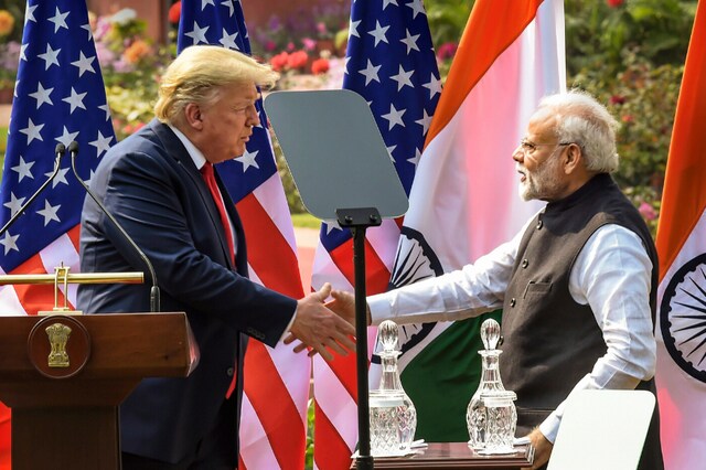 Prime Minister Narendra Modi (R) and US President Donald Trump exchange greetings after their joint press statement, at the Hyderabad House in New Delhi on Tuesday. (PTI)
