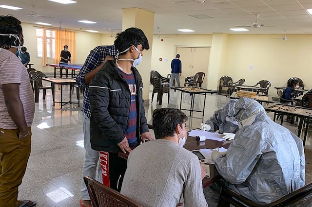 New Delhi: In this handout photo provided by Indo-Tibetan Border Police (ITBP), Indian nationals who were airlifted from coronavirus-hit Hubei province of China's Wuhan, undergo screening at a quarantine facility set by up ITBP, at Chhawla area in New Delhi, Saturday, Feb. 15, 2020. (PTI Photo) 