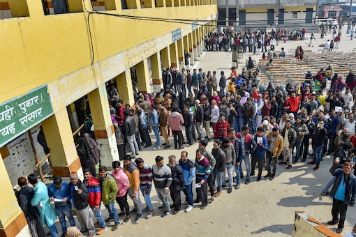 People queue up to vote for Delhi elections on Saturday. (PTI)