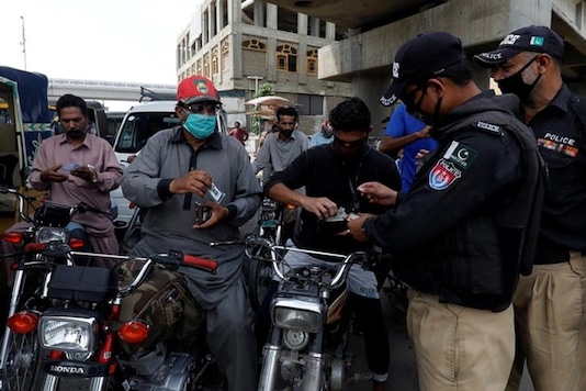Police officers check identity cards of commuters at a checkpoint in Karachi, Pakistan. (Image: REUTERS) Police officers check identity cards of commuters at a checkpoint in Karachi, Pakistan. (Image: REUTERS)
