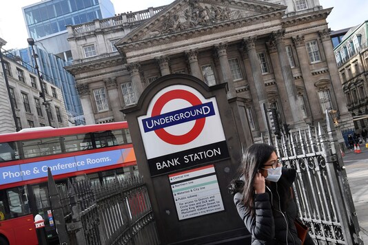 For reprersentation: A woman wearing a protective face mask walks out of an underground tube station in the City of London financial district, whilst British stocks tumble as investors fear that the coronavirus outbreak could stall the global economy, London, Britain. (Image: Reuters)