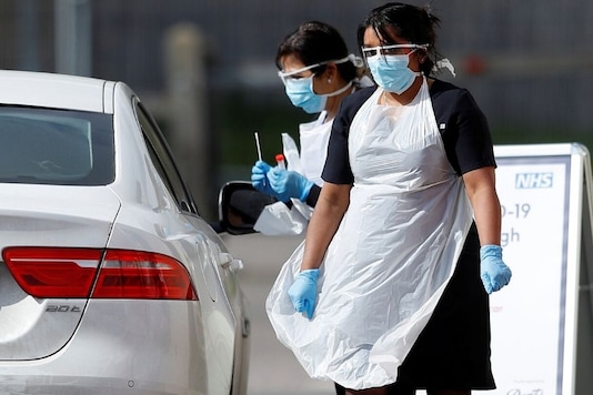 Medical staff at an NHS drive through coronavirus disease (COVID-19) testing facility in the car park of Chessington World of Adventures as the spread of the coronavirus disease (COVID-19) continues, Chessington, Britain, March 28, 2020. REUTERS/Peter Nicholls