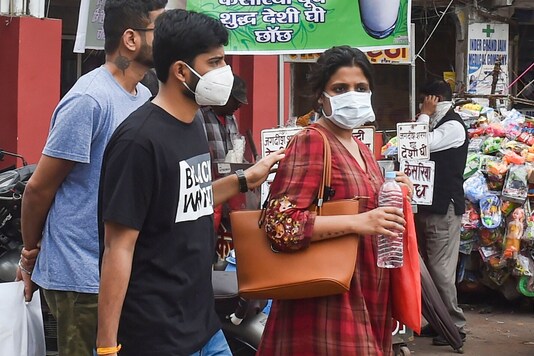 File photo: People wear protective masks in view of coronavirus pandemic at a market in Lucknow. (PTI)