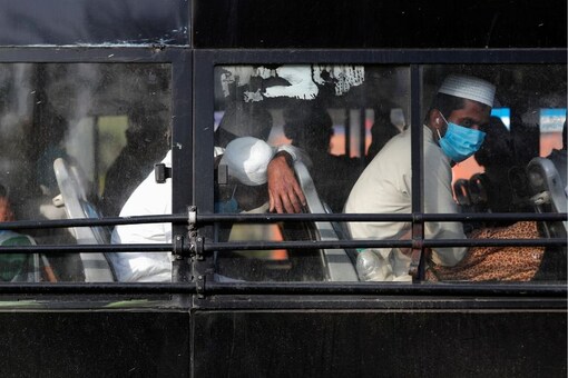 Representative Image. Men wearing protective masks sit inside a bus that will take them to a quarantine facility, amid concerns about the spread of coronavirus disease (COVID-19), in Nizamuddin area of New Delhi, India, March 31, 2020. REUTERS/Adnan Abidi
