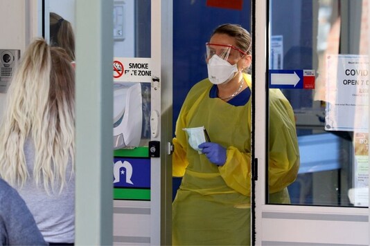 A nurse speaks with patients at the door of a new coronavirus disease (COVID-19) clinic opening at Mount Barker Hospital in Adelaide, Australia. (Reuters)