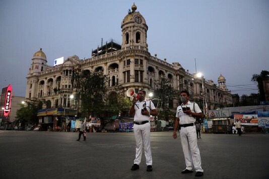 File photo of police officer uses a megaphone advising people to vacate the roads after the lockdown by West Bengal state government to limit the spreading of coronavirus disease (COVID-19), in Kolkata. (Reuters)
