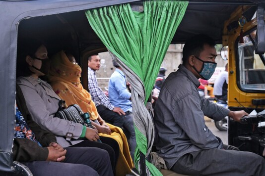 Passengers wear face masks as a precaution against COVID-19 travel in an auto rickshaw in Imphal, Manipur. (AP Photo/Yirmiyan Arthur)