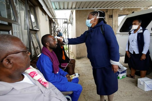 A health worker checks a man's temperature in Durban, South Africa. (Reuters)