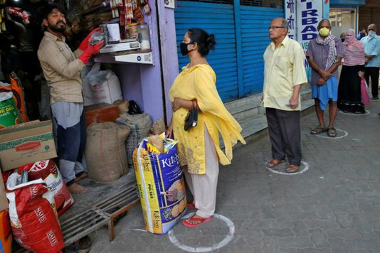 People buy essential items while practising social distancing in Kolkata. (Reuters)