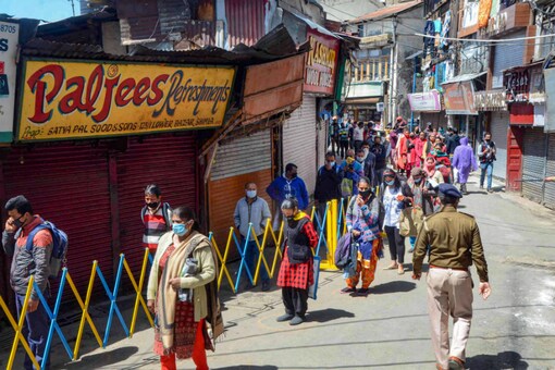 File photo: People maintaining safe distance stand in queue to buy vegetables during the ongoing nationwide lockdown, in Shimla on April 4, 2020. (PTI Photo)