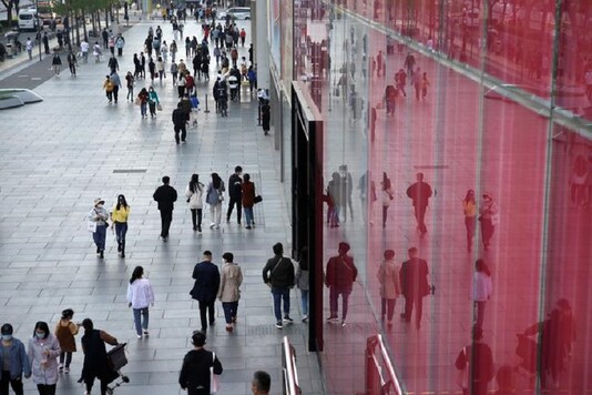 People wearing face masks are seen at a shopping area in Beijing, as the spread of the novel coronavirus disease (COVID-19) continues in the country, China. (Reuters)