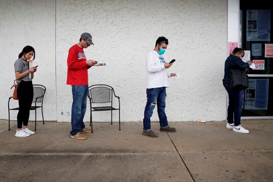 People who lost their jobs wait in line to file for unemployment following an outbreak of the coronavirus disease (COVID-19), at an Arkansas Workforce Center in Fayetteville, Arkansas, US. (Reuters)