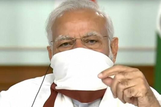 Prime Minister Narendra Modi wears a protective mask while chairing a virtual meeting with chief ministers on Covid-19 response. 