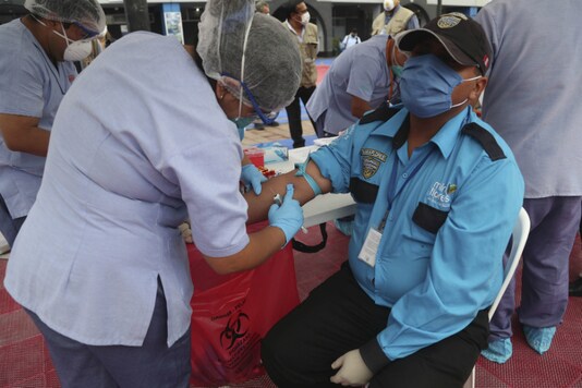 Health workers take blood samples from security guards assigned to the Miraflores district, as they are tested for the new coronavirus in Lima, Peru, on April 13, 2020. (AP Photo/Martin Mejia)