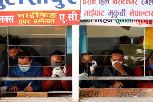 Workers wearing face masks sit inside a bus ticket counter, amid concerns about the spread of the coronavirus disease (COVID-19) outbreak, in Kathmandu, Nepal REUTERS/Navesh Chitrakar - RC2HNF9BS09F