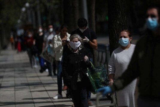 People queue up outside a supermarket while maintaining social distancing amid the coronavirus disease (COVID-19) outbreak in Madrid, Spain. (Reuters)
REUTERS/Susana Vera