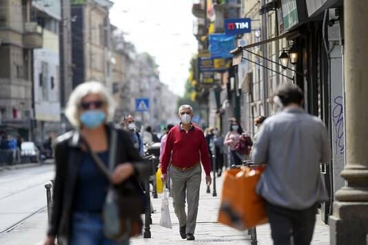 For representation: People wearing protective masks walk in an increasingly busy street, amid the coronavirus disease (COVID-19) outbreak, in Milan, Italy. (Reuters)