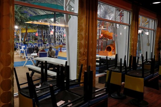 People talk at an indoor water park that is open only to hotel occupants and certain time periods as the spread of the coronavirus disease (COVID-19) continues, from inside a closed restaurant in Rapid City, South Dakota, US.