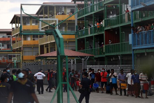 File photo of migrant workers queuing to collect food at the Punggol S11 dormitory during the coronavirus outbreak in Singapore.
(REUTERS/Edgar Su)
