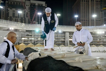 Workers clean and sterilise the roof of Kaaba, following the outbreak of the coronavirus disease (COVID-19), ahead of the holy fasting month of Ramadan, in the Grand mosque in the holy city of Mecca, Saudi Arabia April 21, 2020. Picture taken April 21, 2020. Saudi Press Agency/Handout via REUTERS 