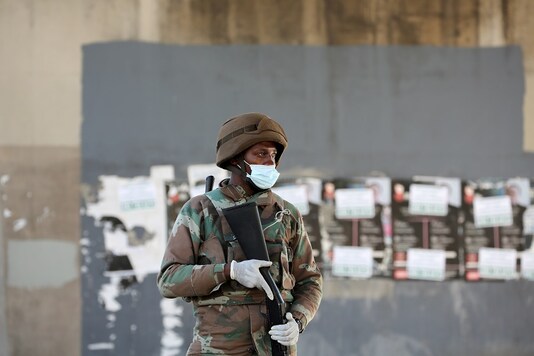  A member of the South African National Defence Force stands guard at a checkpoint as a 21-day lockdown takes effect in Cape Town, South Africa. (Reuters)