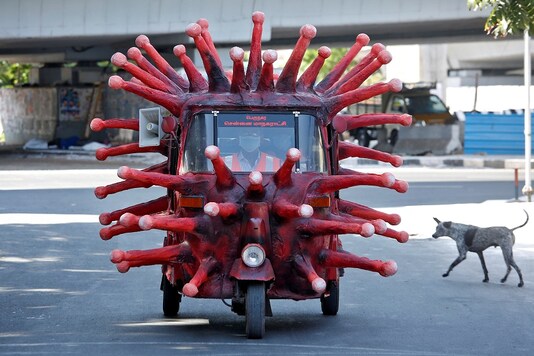 A man drives an auto-rickshaw depicting the coronavirus to create awareness about staying at home during a nationwide lockdown. 

(REUTERS/P. Ravikumar)