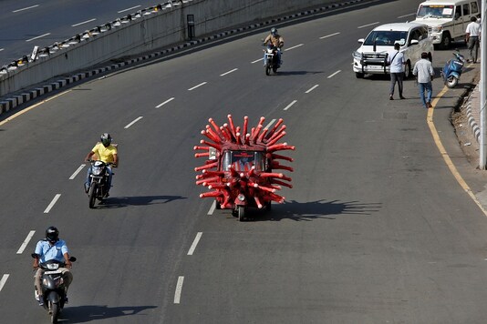 A man drives an auto-rickshaw depicting the coronavirus to create awareness about staying at home during a nationwide lockdown in Chennai. (Reuters)