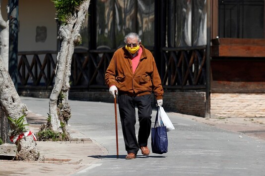 A man wearing a protective face mask and gloves to protect against the spread of the novel coronavirus in Italy. (Credit: REUTERS)