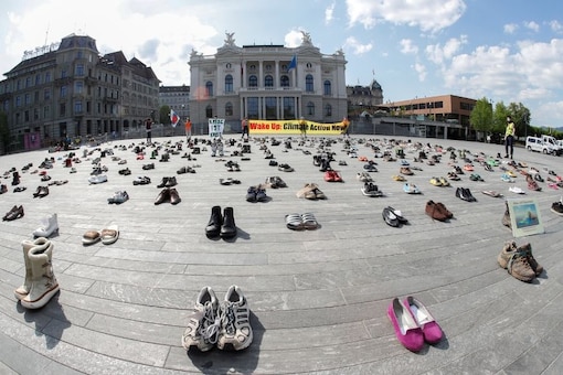Environmental activists of Swiss Klimastreik Schweiz movement hold banners, one of them reads: "Crisis is crisis", after placing shoes in place of live participants to demonstrate against climate change, as the spread of the coronavirus disease (COVID-19) continues, in front of the opera house on the Sechselaeutenplatz square in Zurich, SwitzerlandREUTERS/Arnd Wiegmann