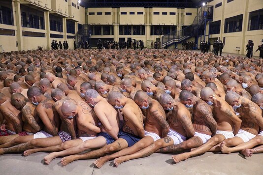 Inmates are lined up during a security operation 
under the watch of police, everyone wearing masks as a precautions amid the spread of the new coronavirus, at the Izalco prison in San Salvador. 

(Credit: El Salvador President Press Office via AP)