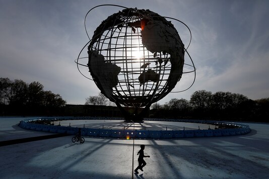 A child plays under The Unisphere in Flushing Meadows-Corona Park during the outbreak of the coronavirus disease (COVID-19) in the Queens borough of New York City, U.S. REUTERS/Andrew Kelly/File Photo