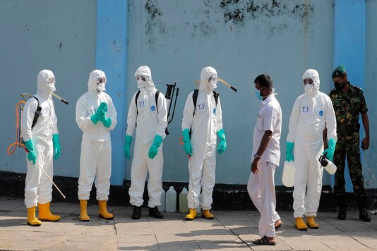 Sri Lankan police commandos prepare to spray disinfectants in a hospital in Colombo, Sri Lanka. (AP Photo)