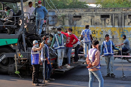 Road maintenance workers work during a nationwide lockdown as a precautionary measure against COVID-19 in Hyderabad, Telangana. (AP)