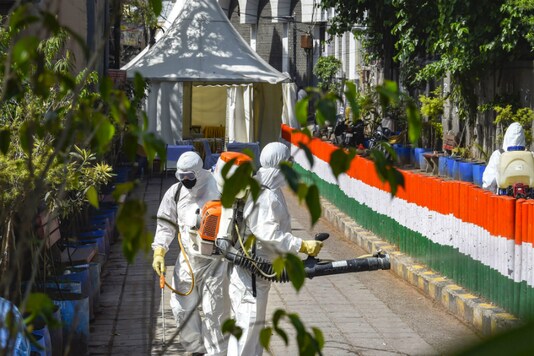 File photo of sanitation workers cleaning an area near the Nizamuddin Mosque where the Tablighi Jamaat event was held in March in New Delhi.  (PTI)