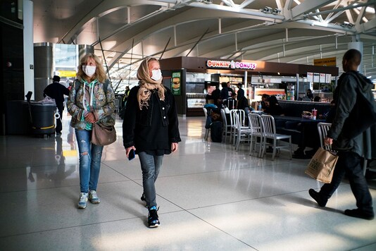 People walk around terminal one at JFK airport after the Federal Aviation Administration temporarily halted flights arriving at New York City airports due to coronavirus disease (COVID-19) in New York, US. (Reuters)