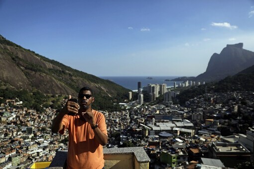 A community leader livestreams an alert message on social media in Rocinha slum, during the coronavirus disease (COVID-19) outbreak, in Rio de Janeiro, Brazil. (Reuters)