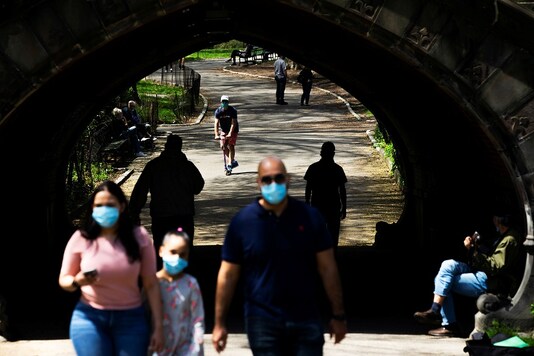 People walk at Central Park maintaining social distancing norms, during the outbreak of the coronavirus disease (COVID-19) in the Manhattan borough of New York City, US. (Reuters)