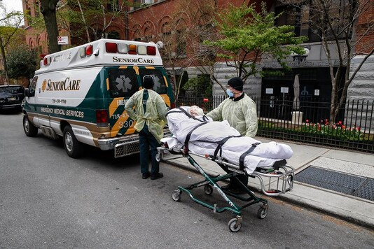 A patient is wheeled out of Cobble Hill Health Center by emergency medical workers in the Brooklyn borough of New York. (AP Photo)