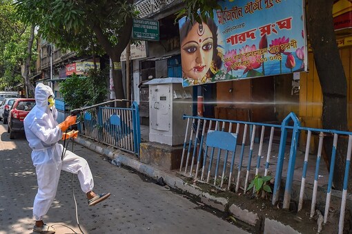 File photo of Kolkata Municipal Corporation worker in a protective suit sanitising the city. (PTI)