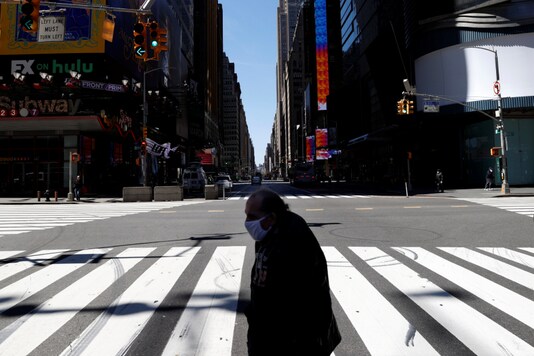 A man wearing a protective face mask crosses 7th Avenue in a nearly deserted Times Square in Manhattan during the outbreak of the coronavirus disease (COVID-19) in New York City, New York, US, May 5, 2020. (Image: Reuters)