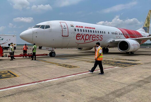 Airport staff conduct pre-departure verification of an Air India Express flight to the UAE to bring stranded Indian nationals back, during the ongoing COVID-19 national blockade in Kochi. (Image: PTI)