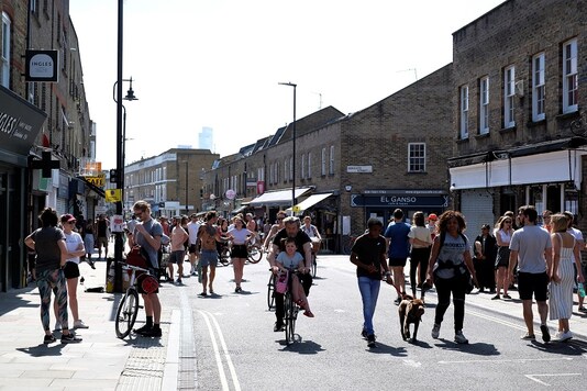 People walk and cycle along Broadway Market, following the outbreak of the coronavirus disease (COVID-19), London, Britain, May 9, 2020. REUTERS/John Sibley