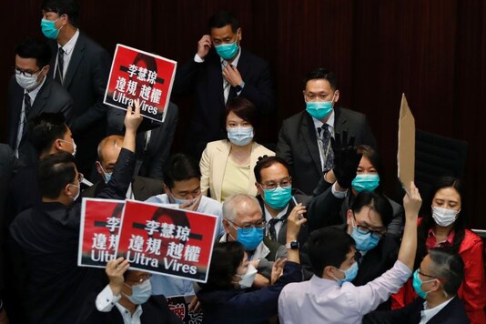 Pan-democratic legislators surround pro-China legislator Starry Lee during a Legislative Council's House Committee meeting, in Hong Kong, China. (Image: Reuters)